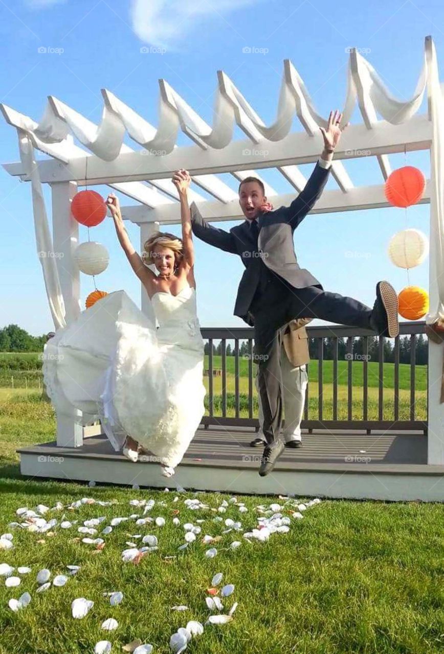 Jumping for joy. Newly married couple at Greenbluff, Spokane, WA