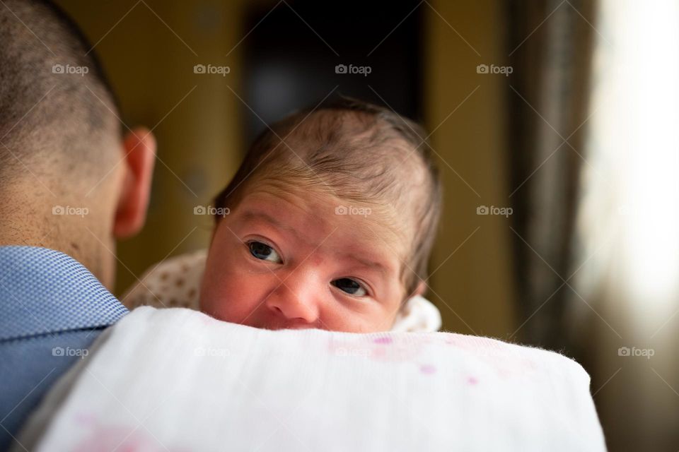 baby girl on dad's shoulders