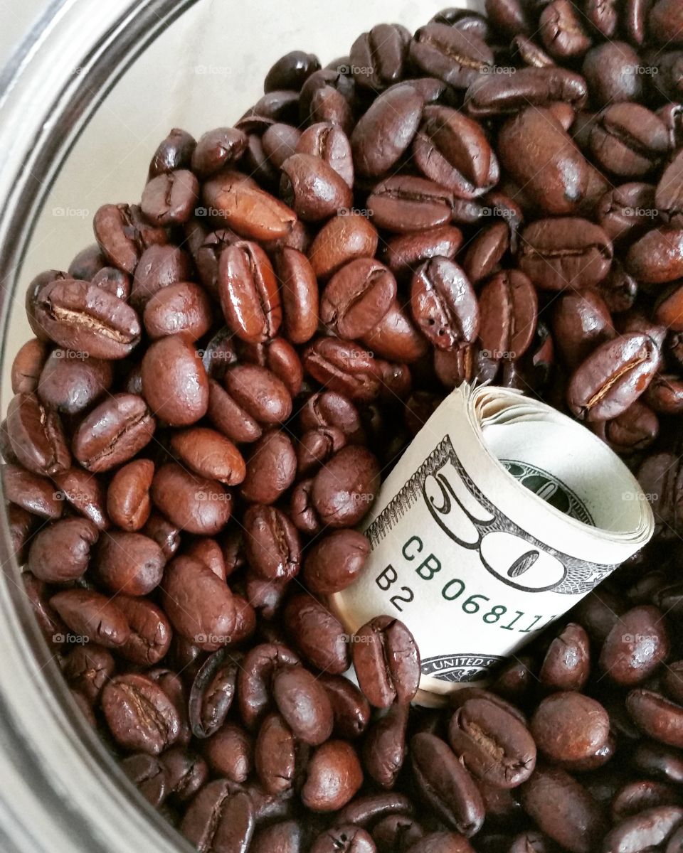 Bowl of roasted coffee beans with american dollar