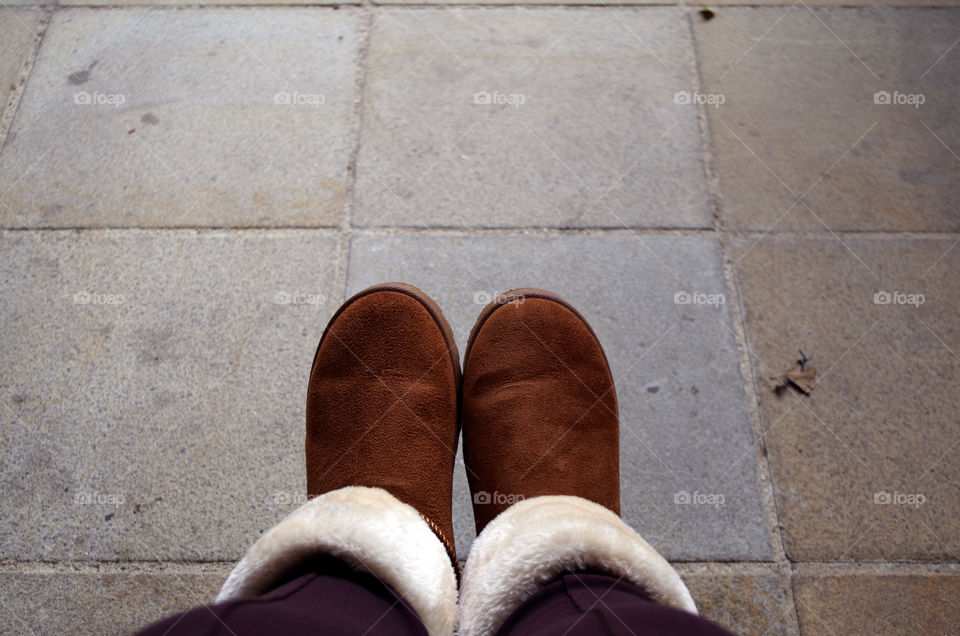 Low section of human legs wearing shoes in Kraków, Poland.