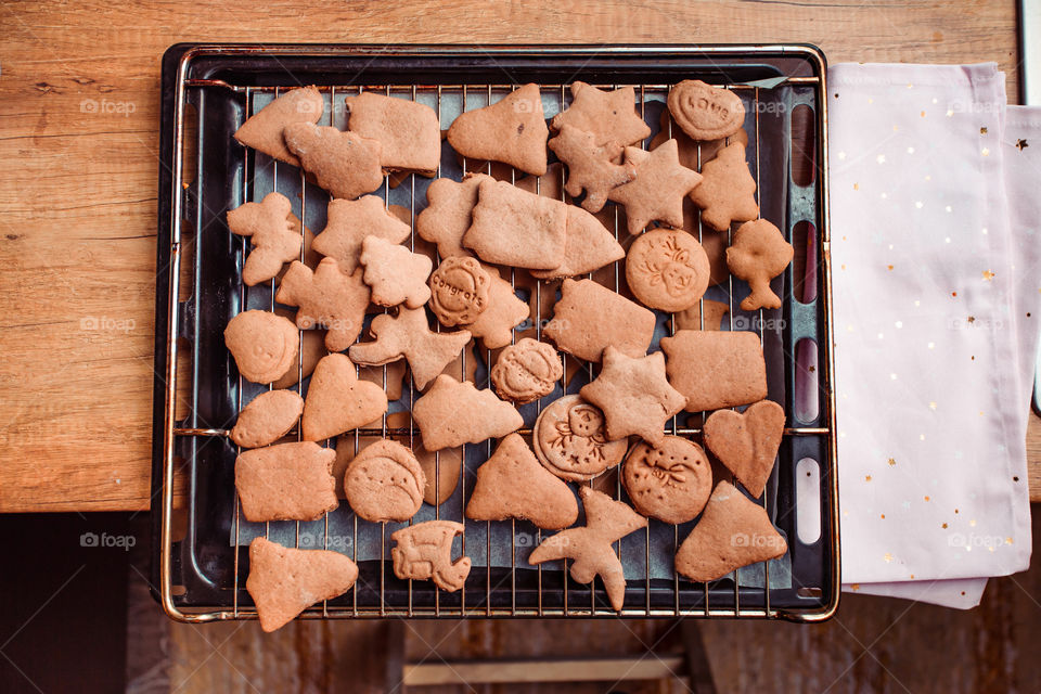 Baking Christmas cookies. Christmas gingerbread cookies in many shapes decorated with colorful frosting, sprinkle, icing, chocolate coating, toppers, put on table. Baking traditional cookies. Family celebrating Christmas. Baking at home
