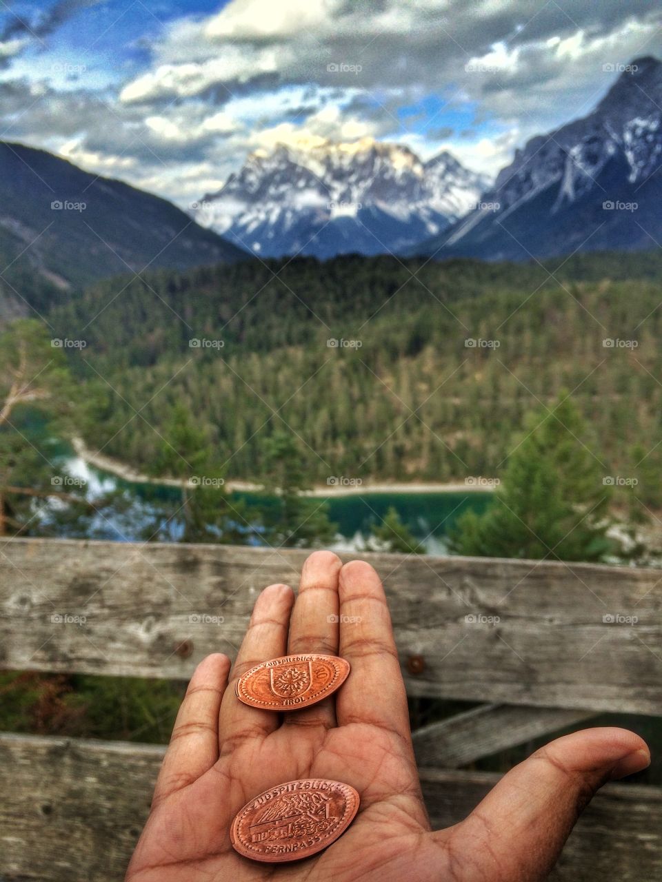 Coins on hand and beautiful nature background 