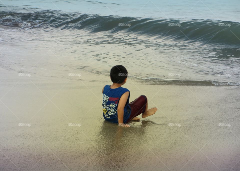A boy playing at the beach