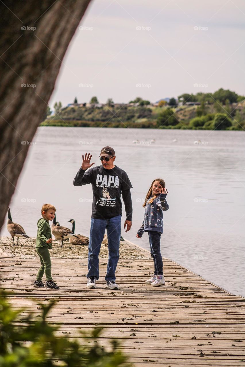 Papa and his grandchildren walking along a pier In Klamath falls Oregon 
