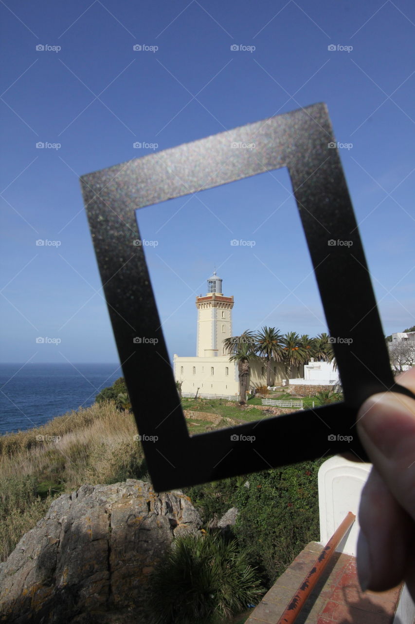 Lighthouse in frame on coast outside tangier 
