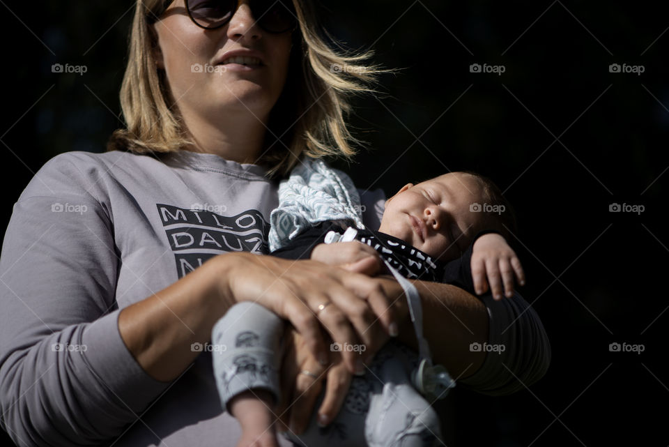 Mother holding newborn baby boy