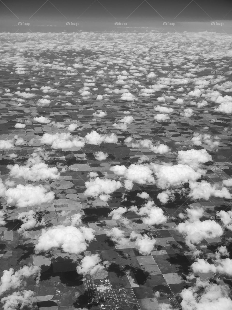 Black and white exposure highlights the finely dotted cloud landscape high above Kansas