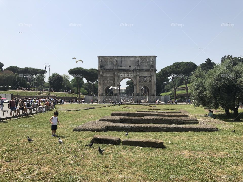 Sunny day historical place in Rome child birds people 