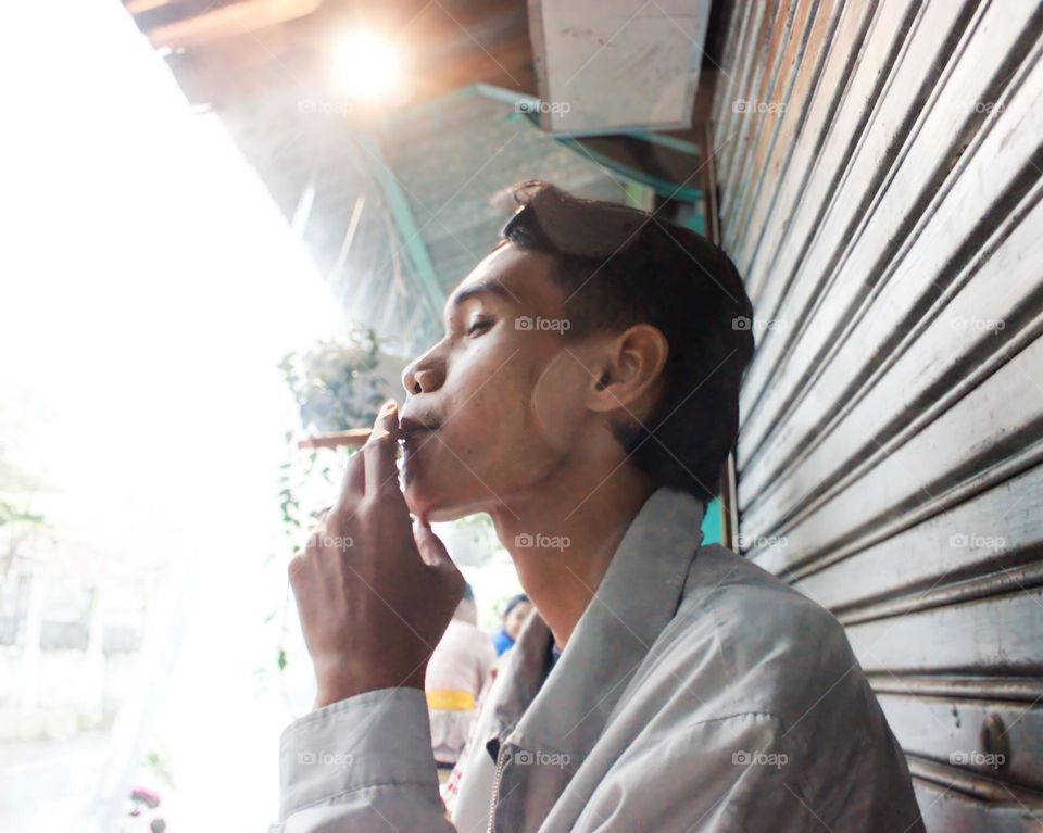 man smoking cigarette in the cafe