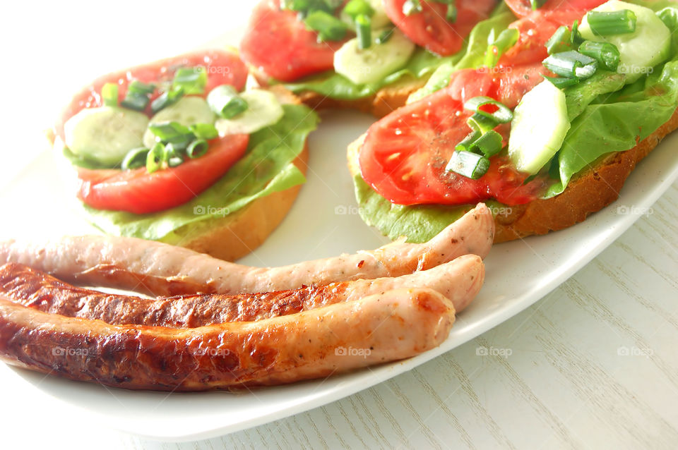 Perfect breakfast with sausages, tomatoes and greenery