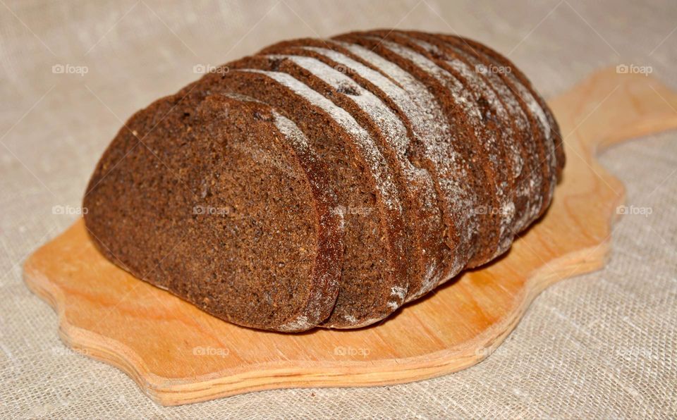 tasty healthy black bread on a wood board natural background