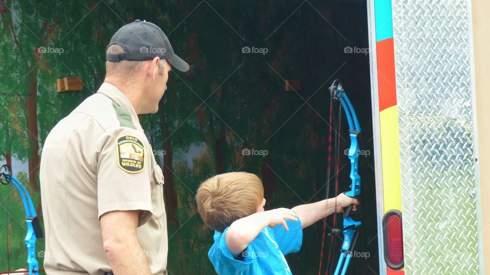 Child using bow and arrow