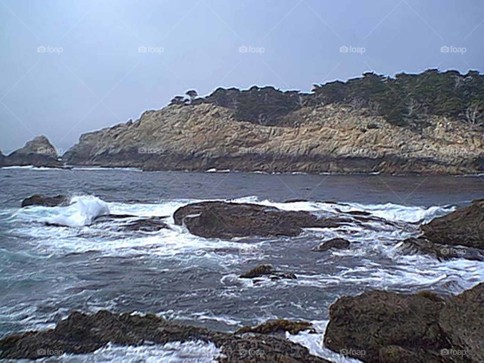 Waves settling in rocky area 