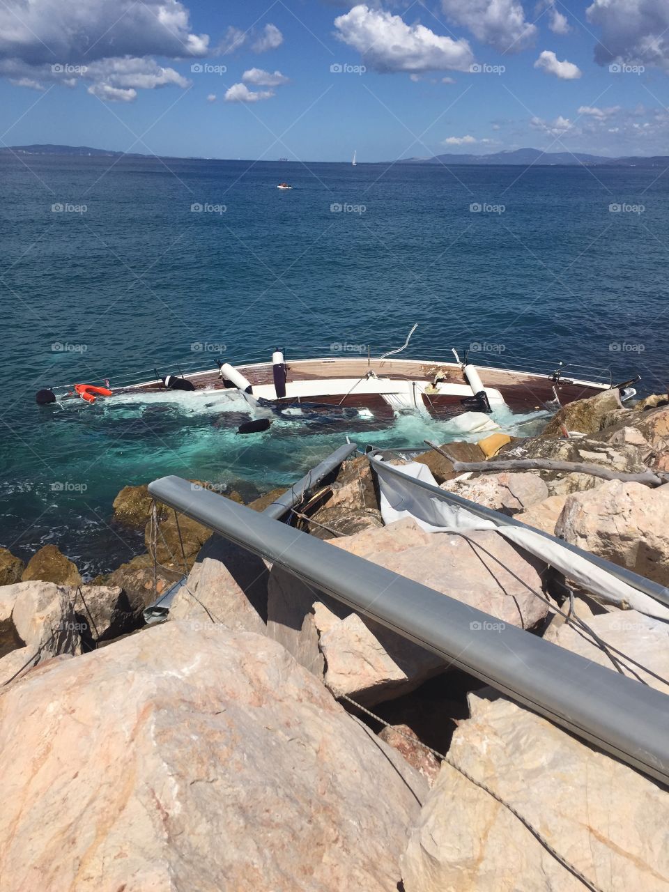 Abandoned sailboat crashed on rocks 