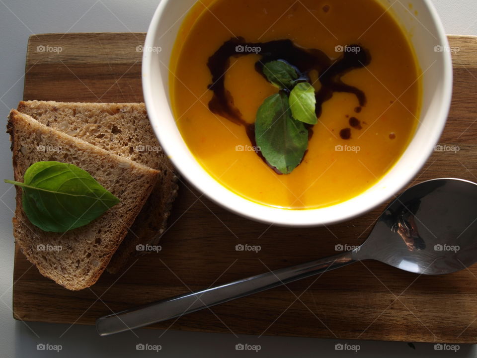 Delicious pumpkin soup with bread