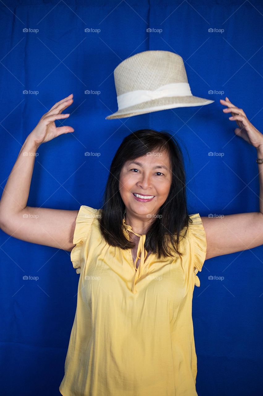 Portrait of a woman having fun with her hat