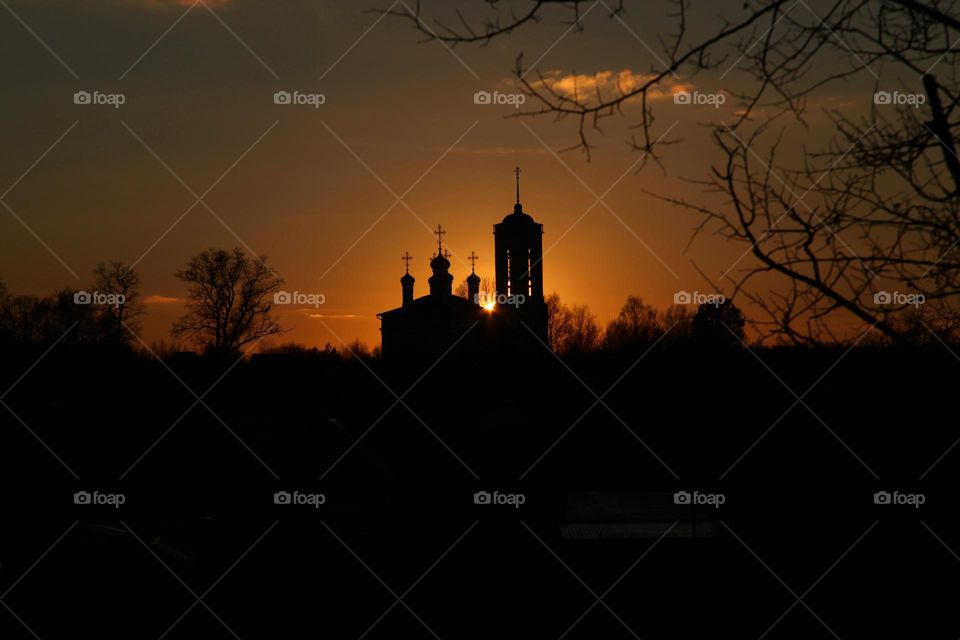 church at sunset covers the sun