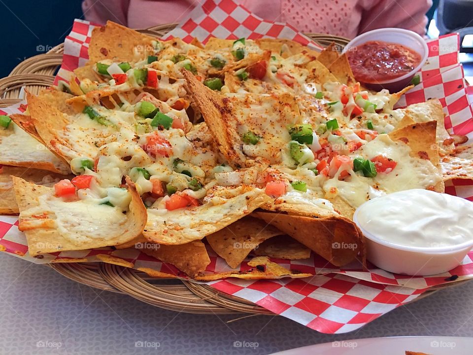 Nachos with salsa, melted cheese and sour cream