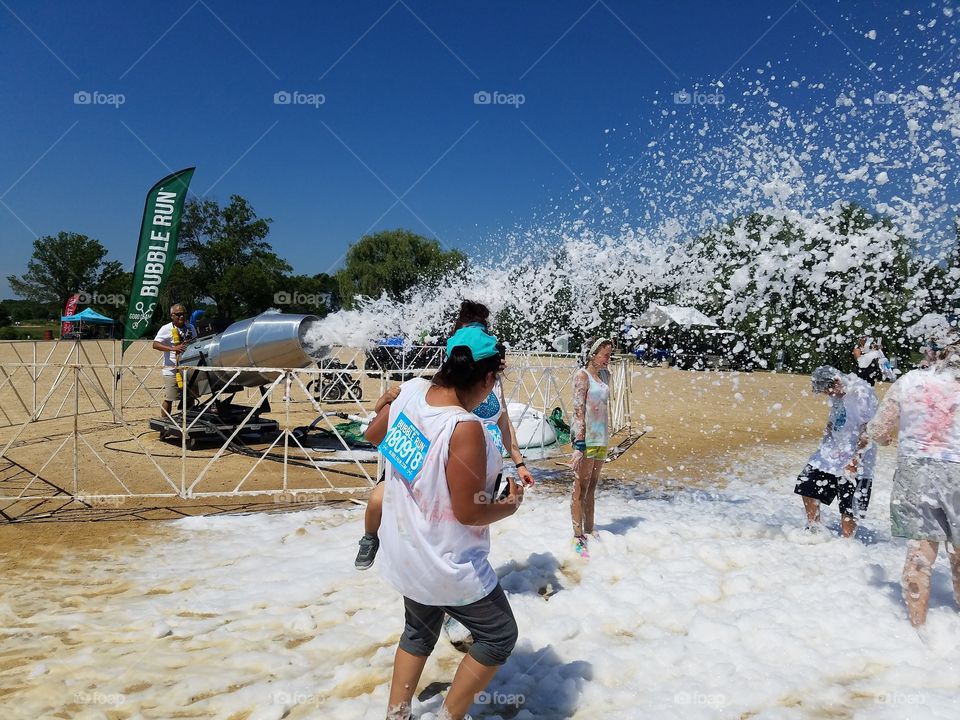 Foam machine throwing foam at bubble run festival