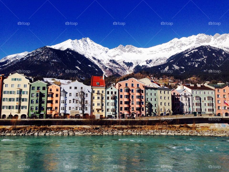 Colorful houses riverside with snow mountains