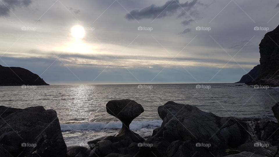 A mushroom-shaped eroded rock by the sea, Kannnestein Rock. Norway.