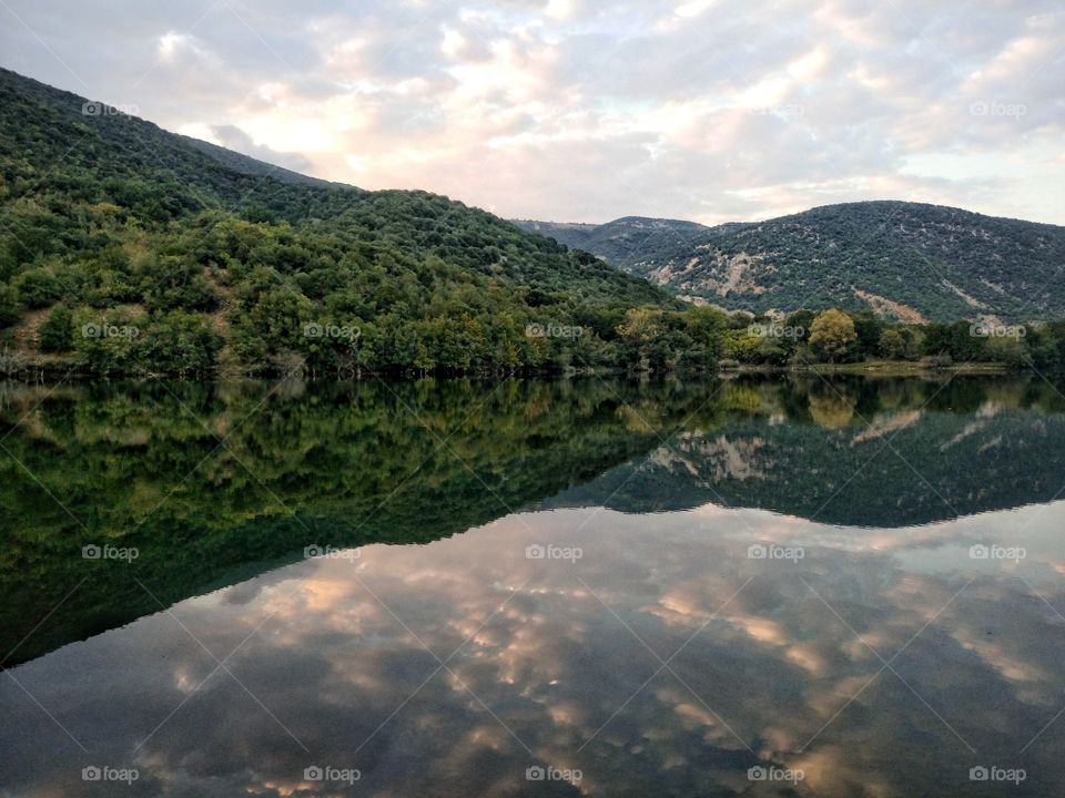 Reflection of mountain and trees in river