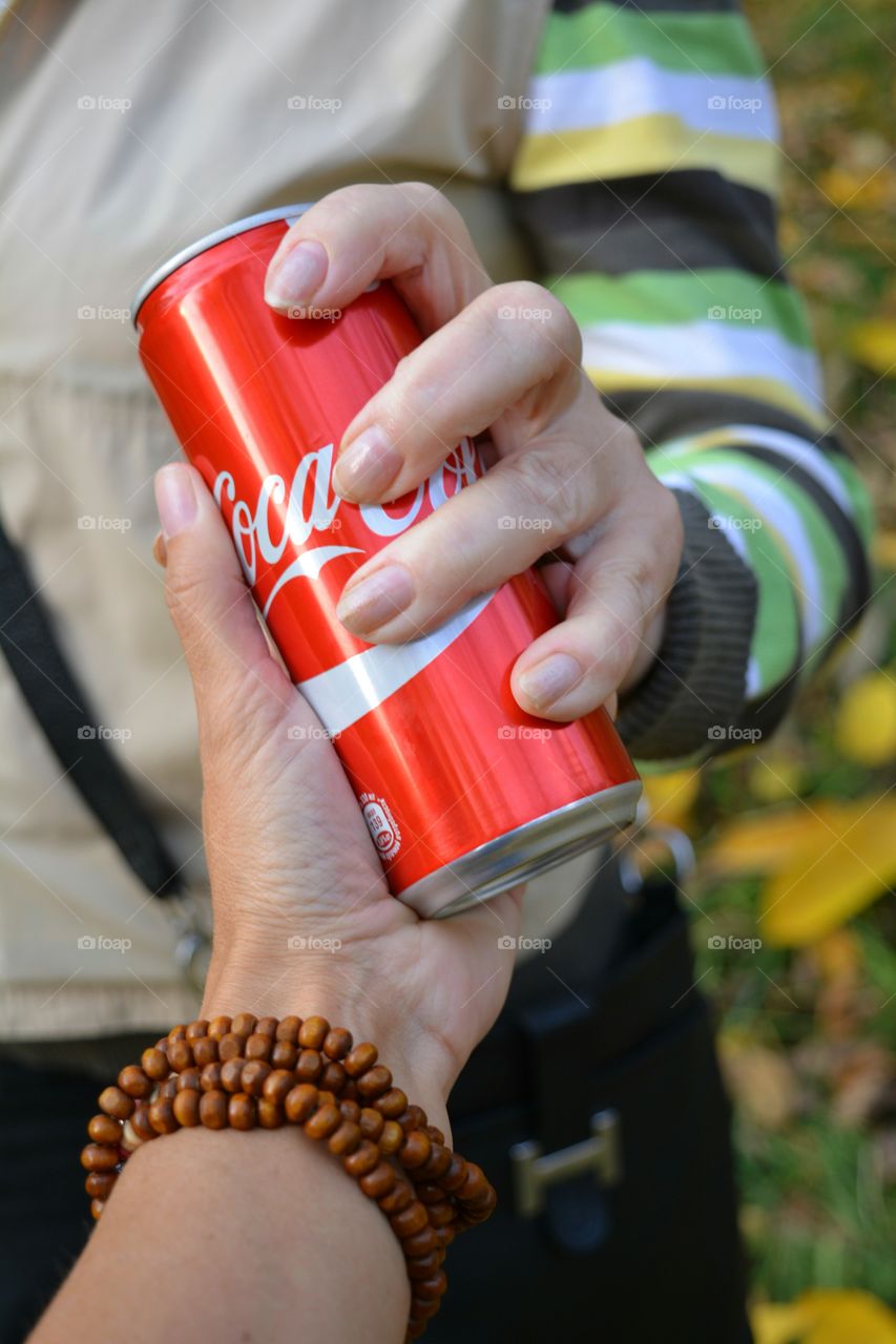 coca cola drink in hands female