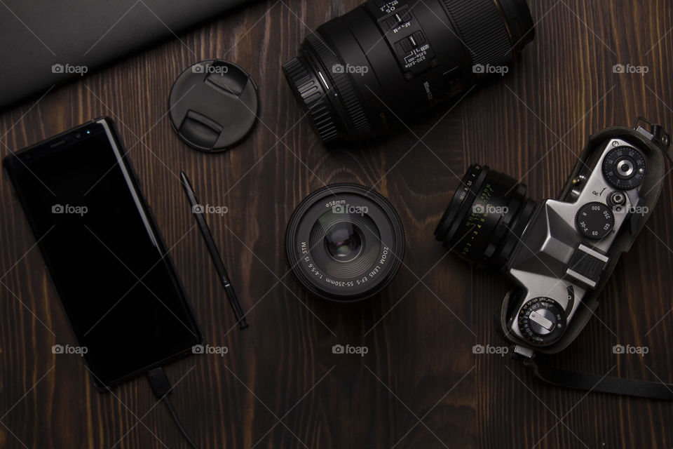 top view of camera , lenses and smartphone.  photography concept.  flatlay view