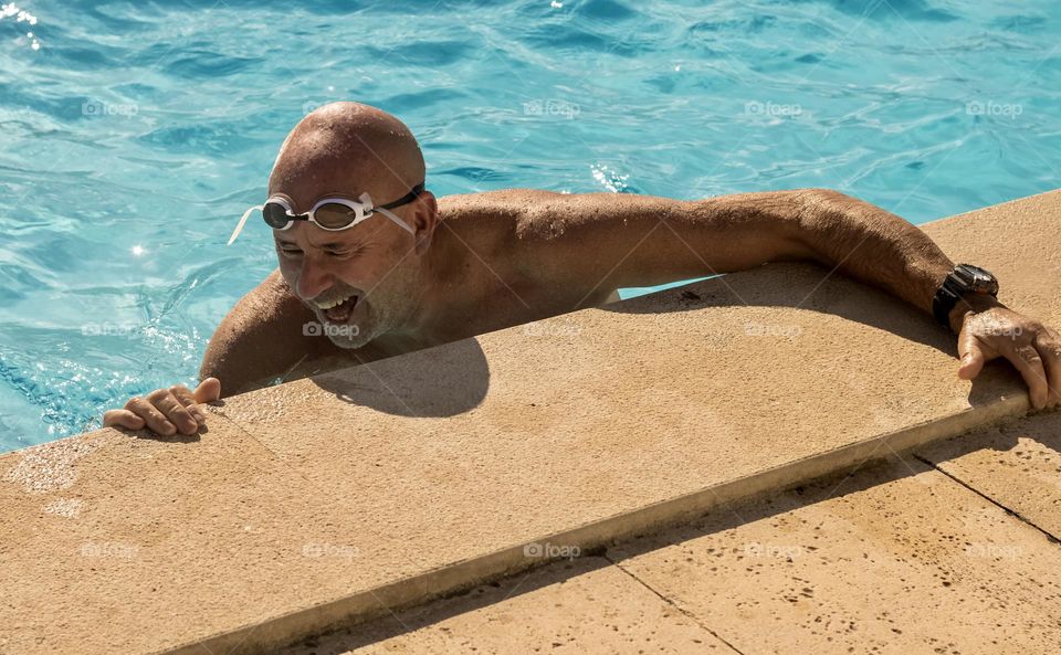 Dad of 6 having a good laugh in the swimming pool.