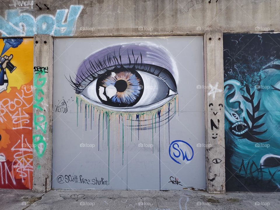 Street art- lavender color eye with colorful tears