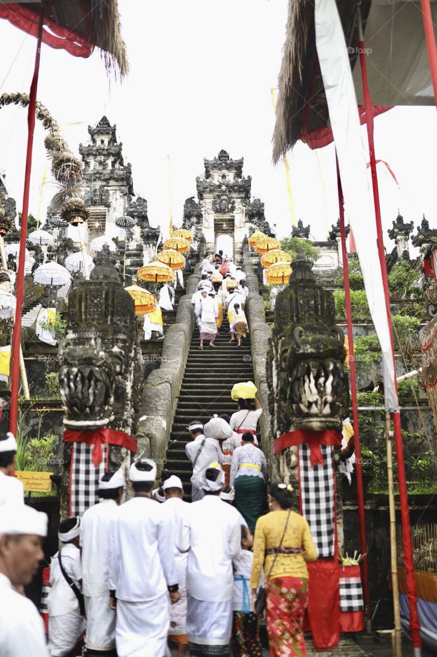 Traditional Hindu ceremony taking place in Bali, Indonesia at a gorgeous temple. 