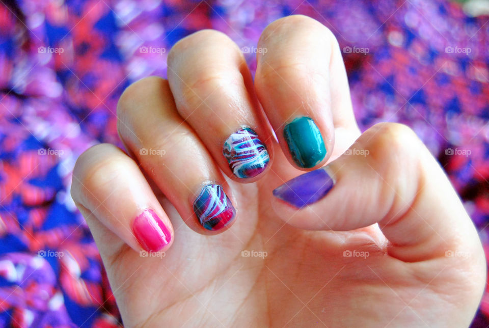 water marble nail art in purple, magenta, bluegreen and white