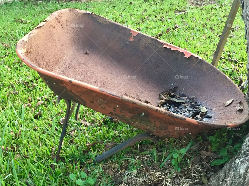 Old rusted and broken wheelbarrow