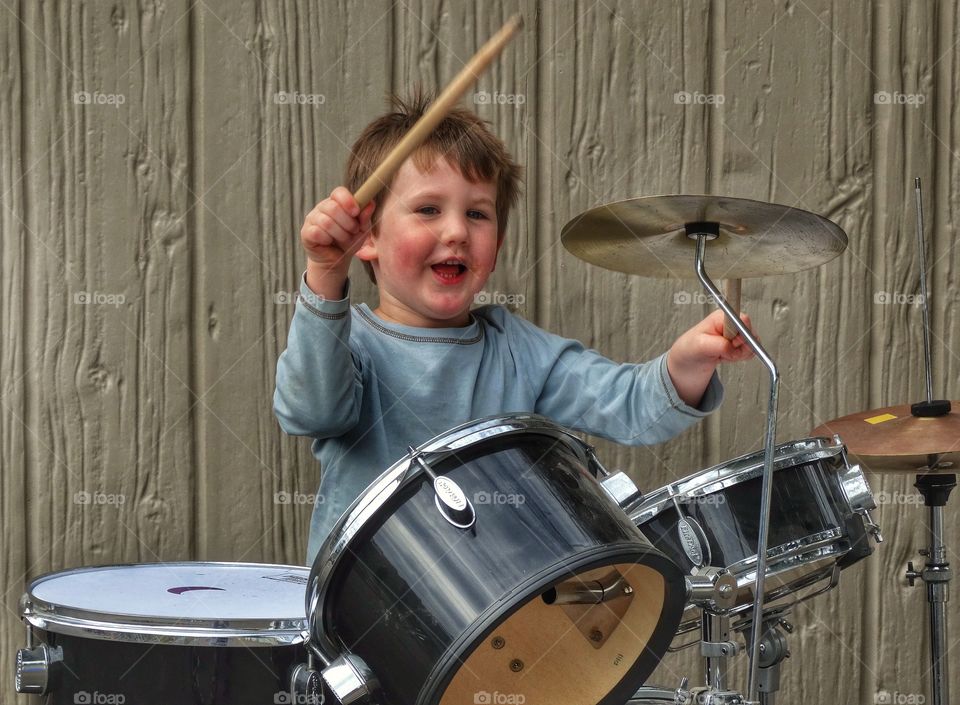 Joyful Boy Playing Drums