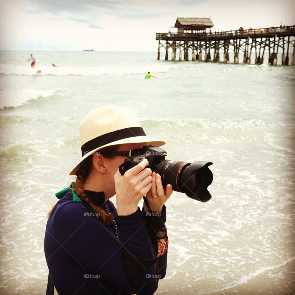 Photographer on the beach and pier