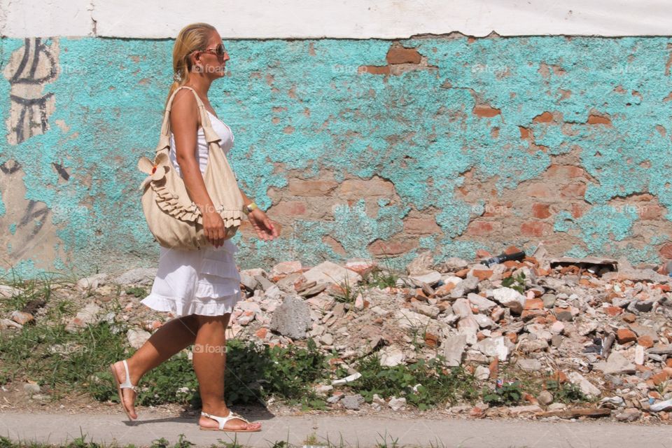 Cuban People.Woman walking on pavement sidewalk