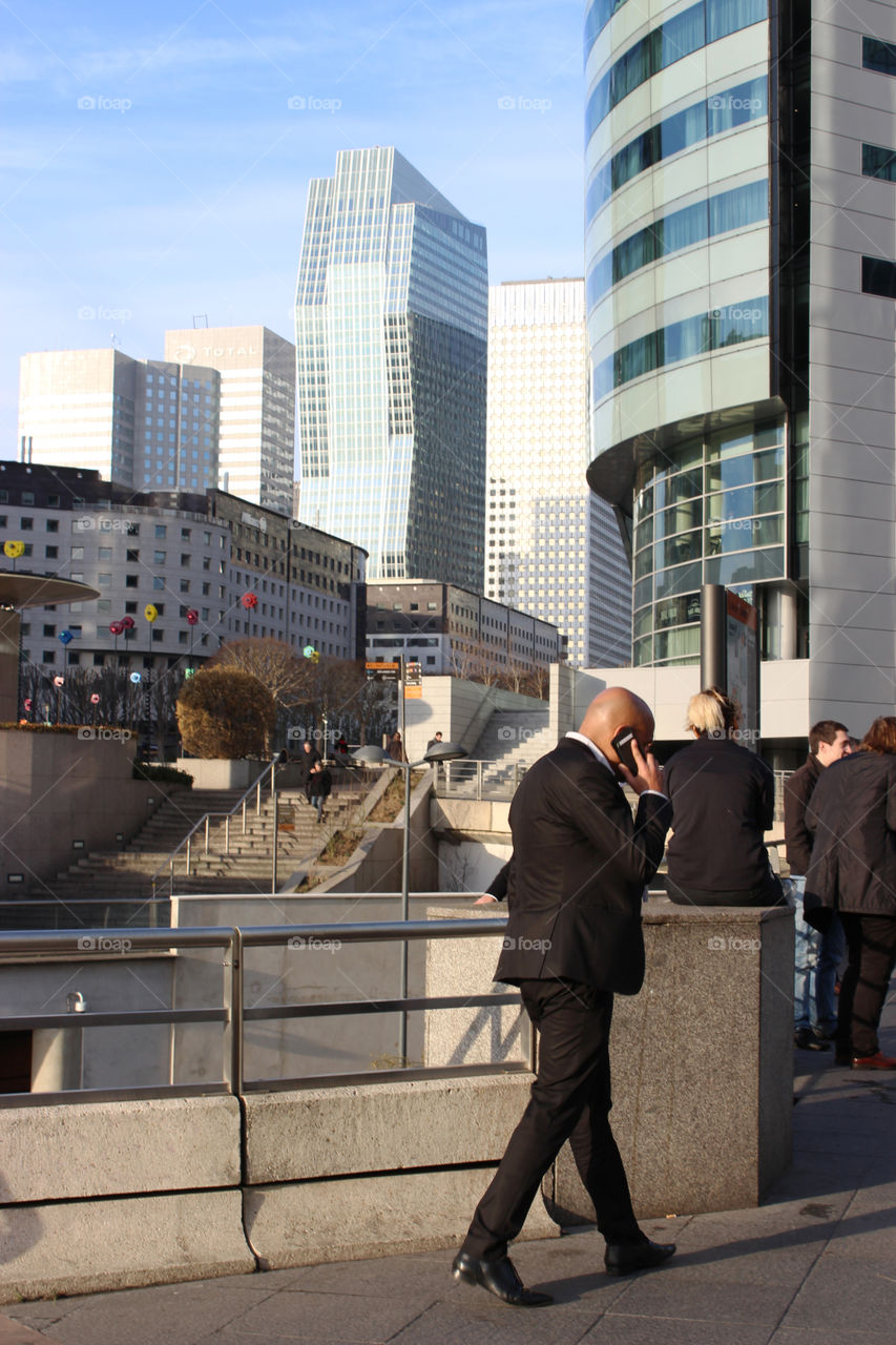 Business man beside the modern buildings in the financial district,Le Defence.
Paris.