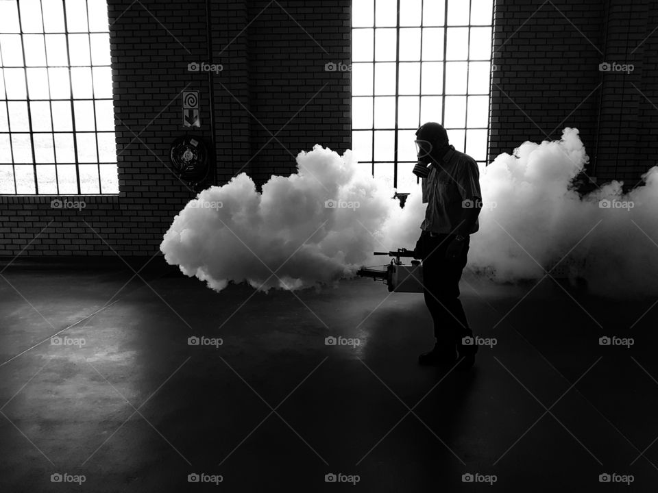black amd white of person fogging a building