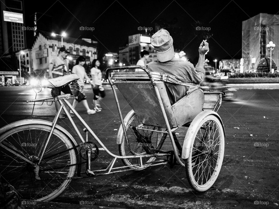 A tricycle waiting for customer on the street of Saigon at night