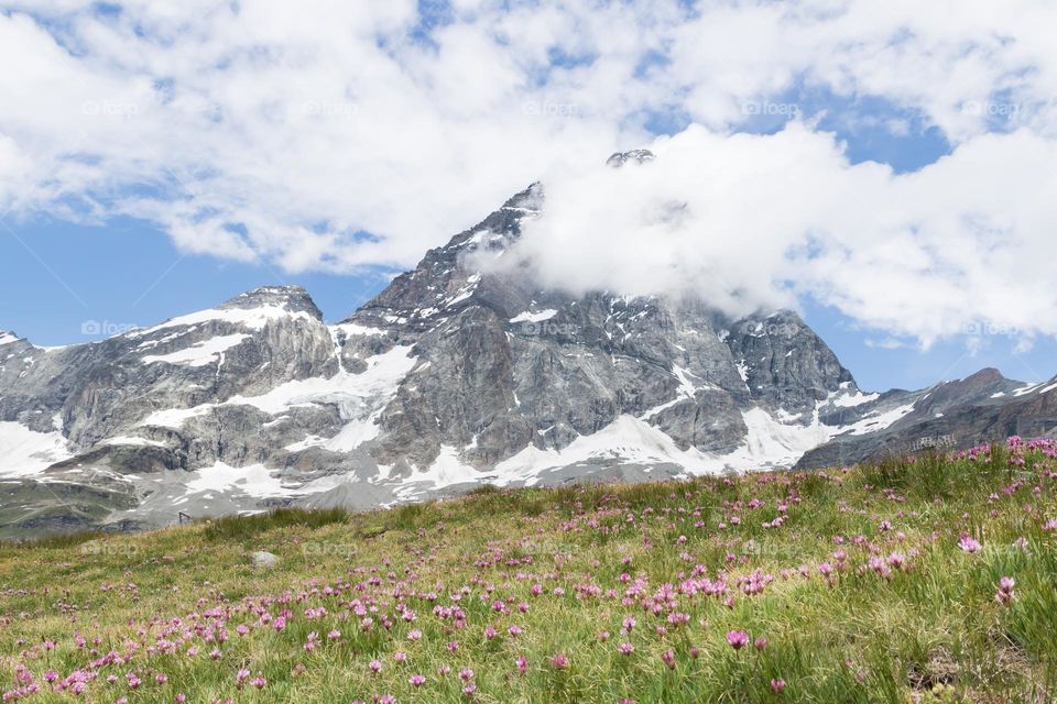 Beautiful mountain Matterhorn surrounded by clouds in summer, view from Italy
