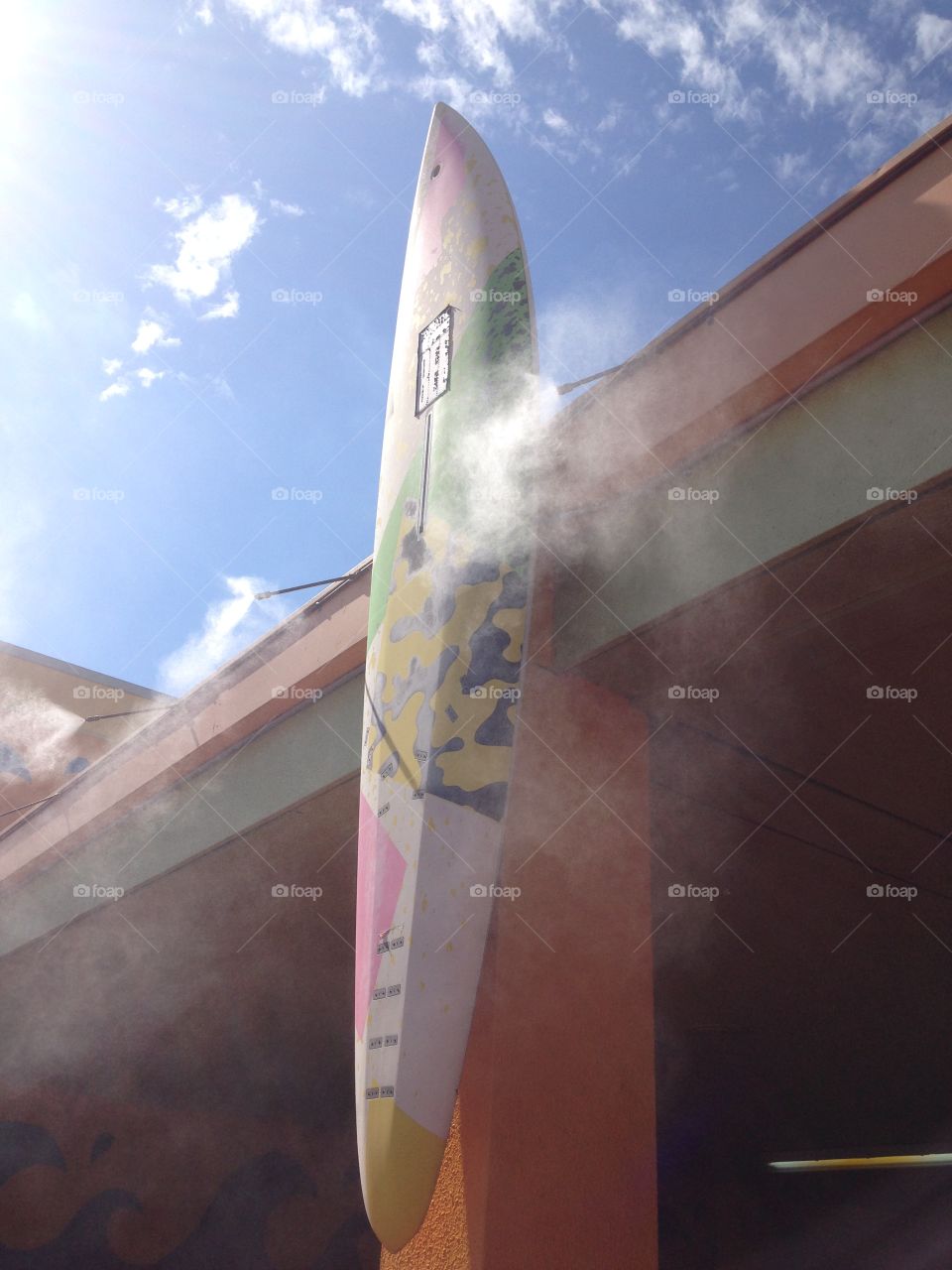 Surf's up . Surf board in the misters at water park