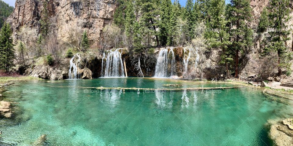 Beautiful crystal clear water flowing from a waterfall into a Colorado lake high in the mountains. 