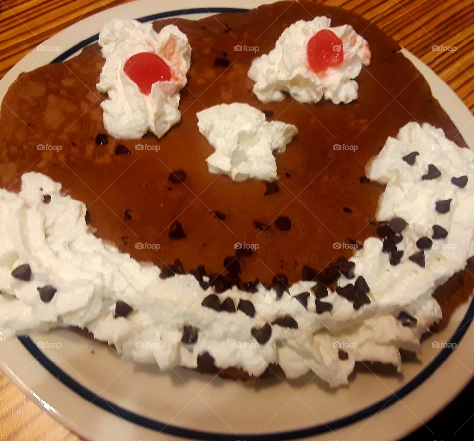 Funny Face Pancake,whipped cream, chocolate chips, smiling