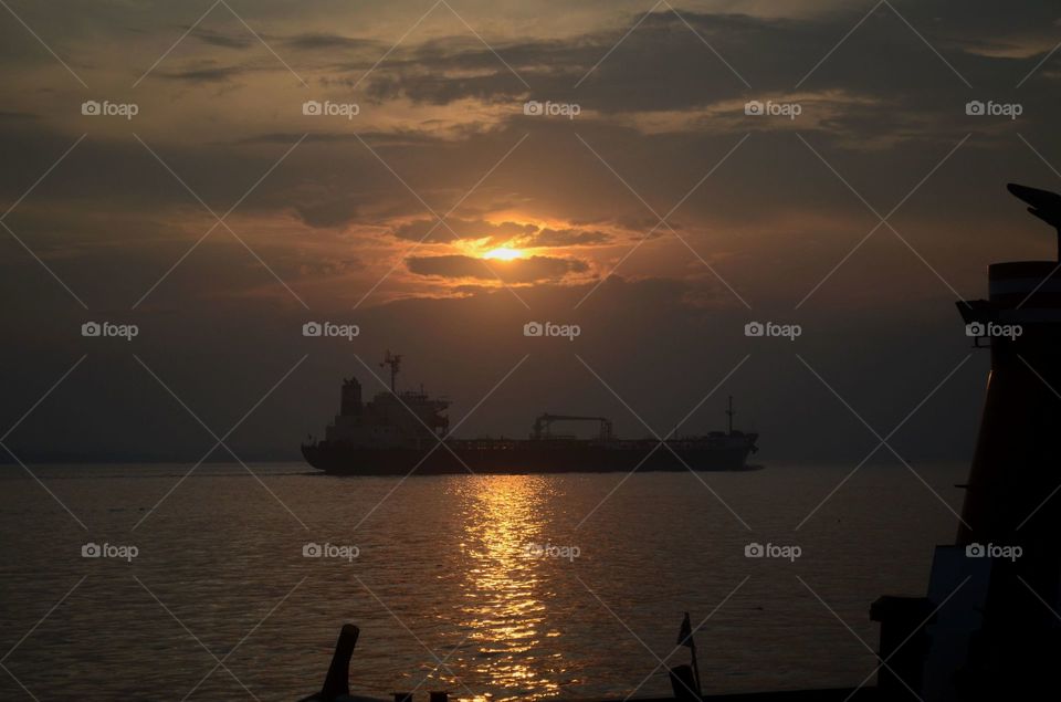 ship in the middle of sunset