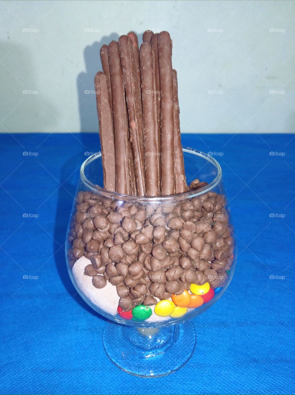 Chocolate pretzels, chocolate tidbits,  chocolate nips in different colors & chocolate marshmallows in the goblet glass.