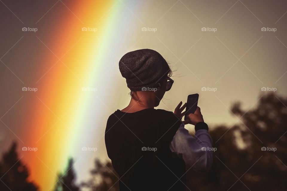 Rear view of a woman using cellphone