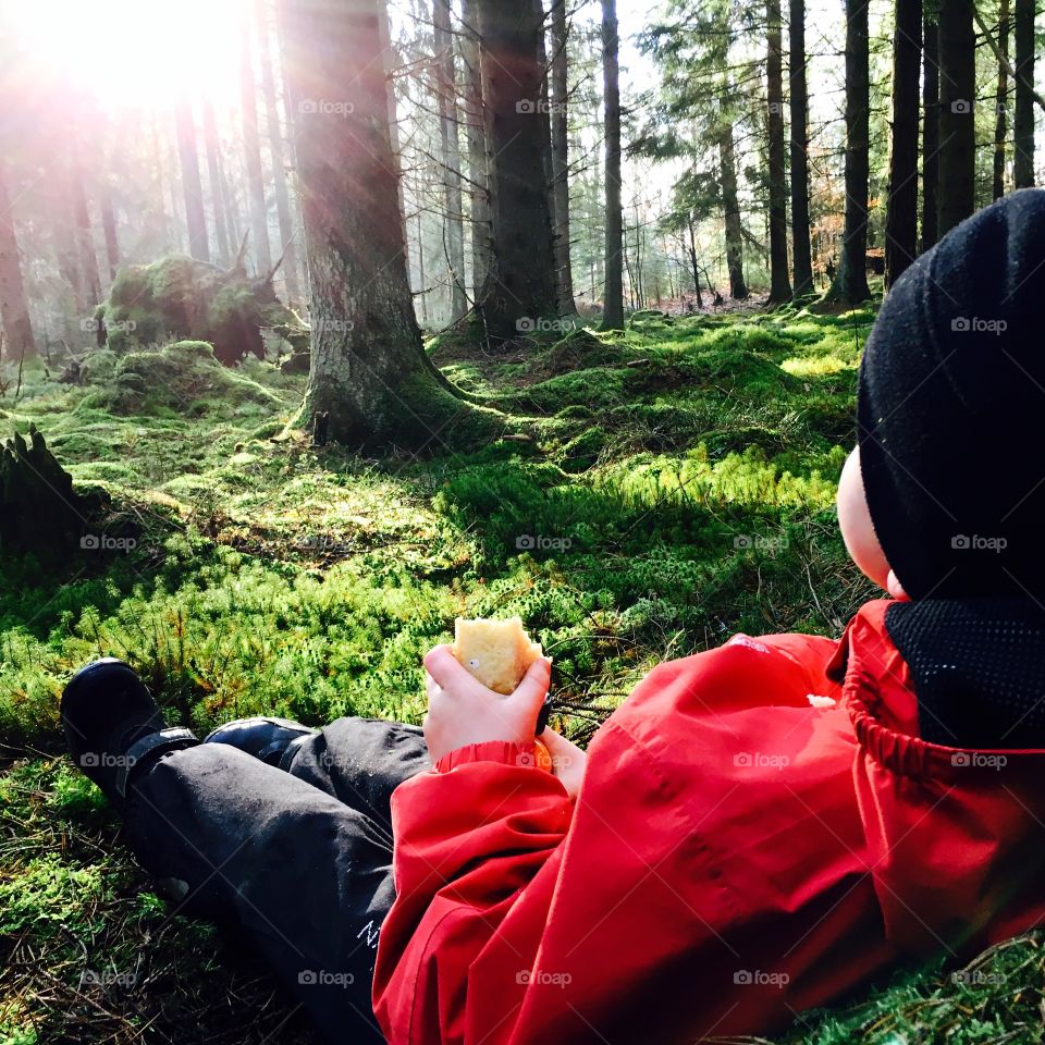 Boy relaxing in the woods