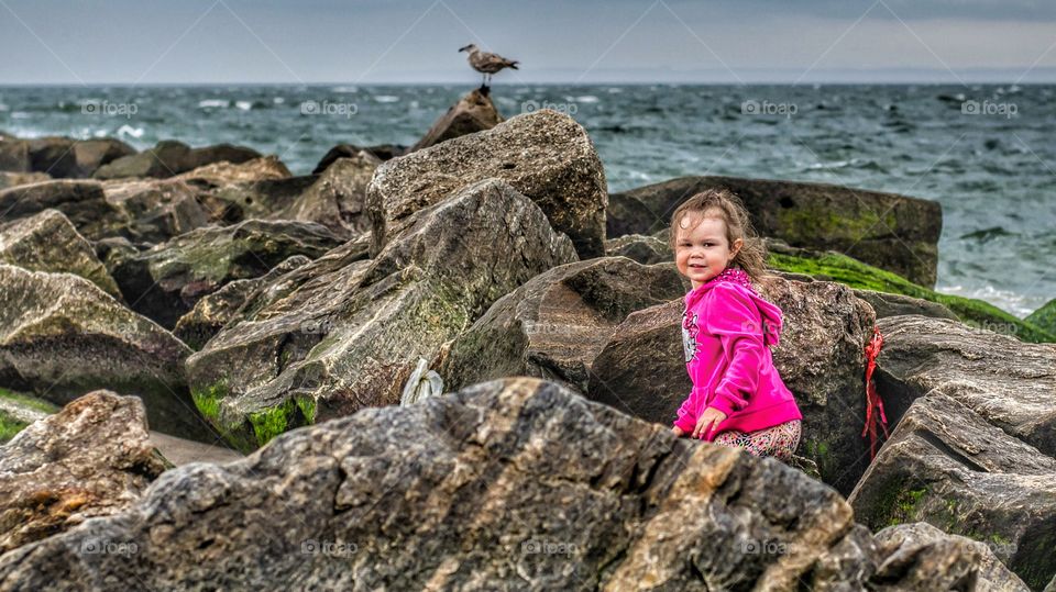 Little girl standing in rock