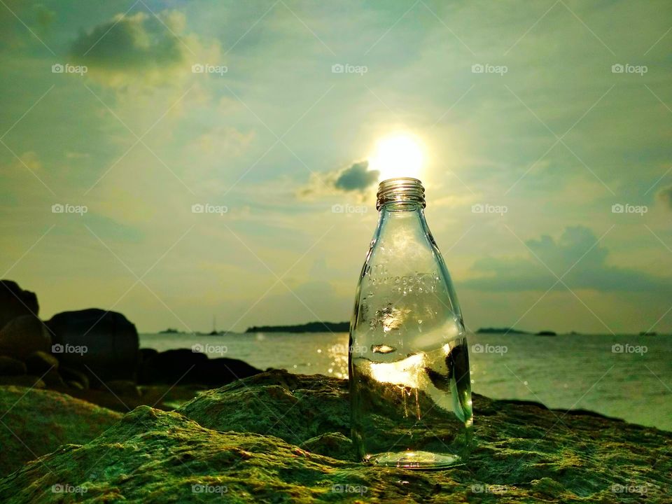 light on the beach rocks bottle