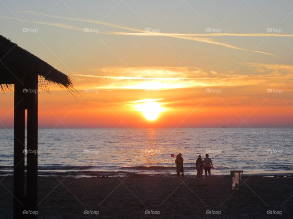 sunset . People enjoy on the beach and beautiful sunset